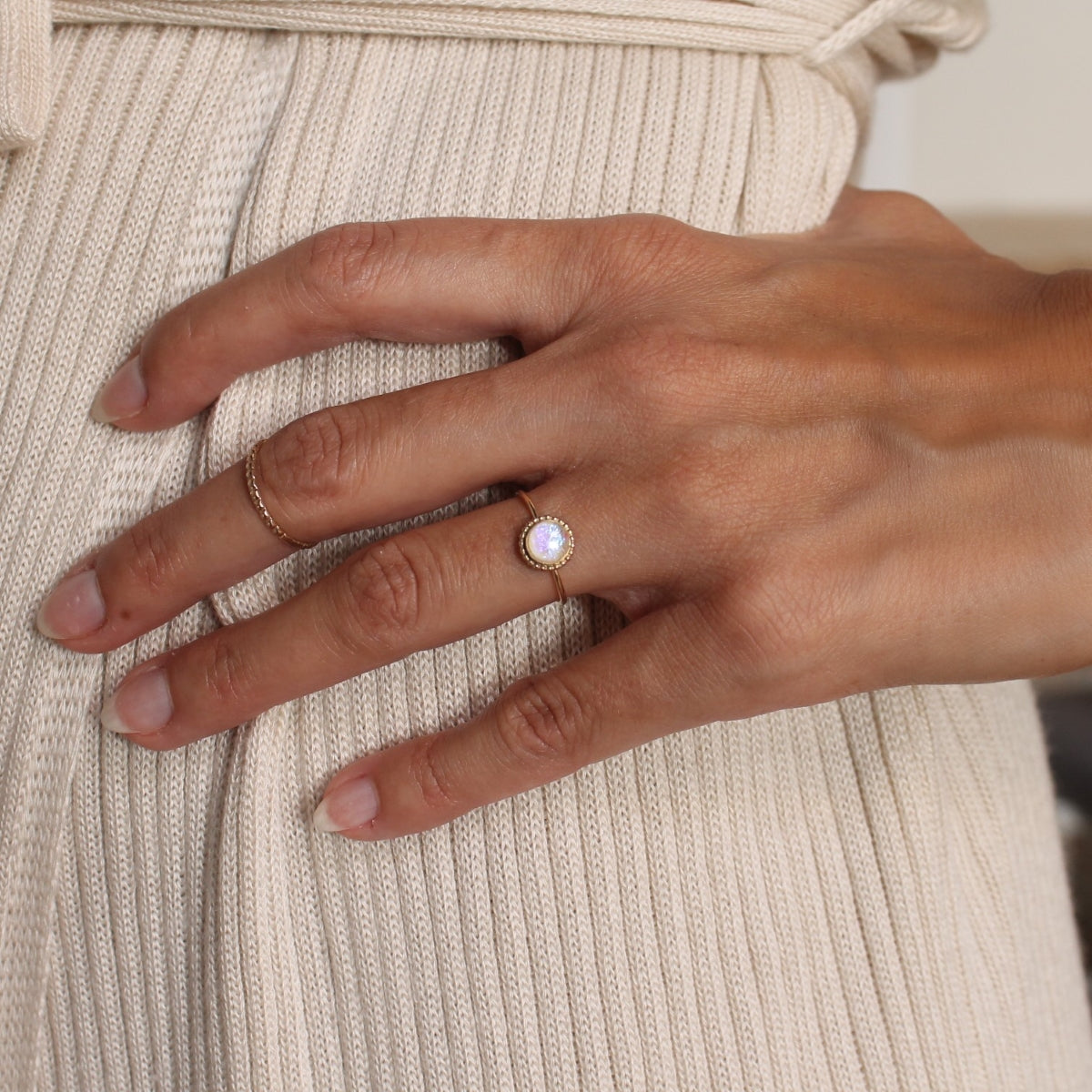 Model wearing a gold round opal statement ring