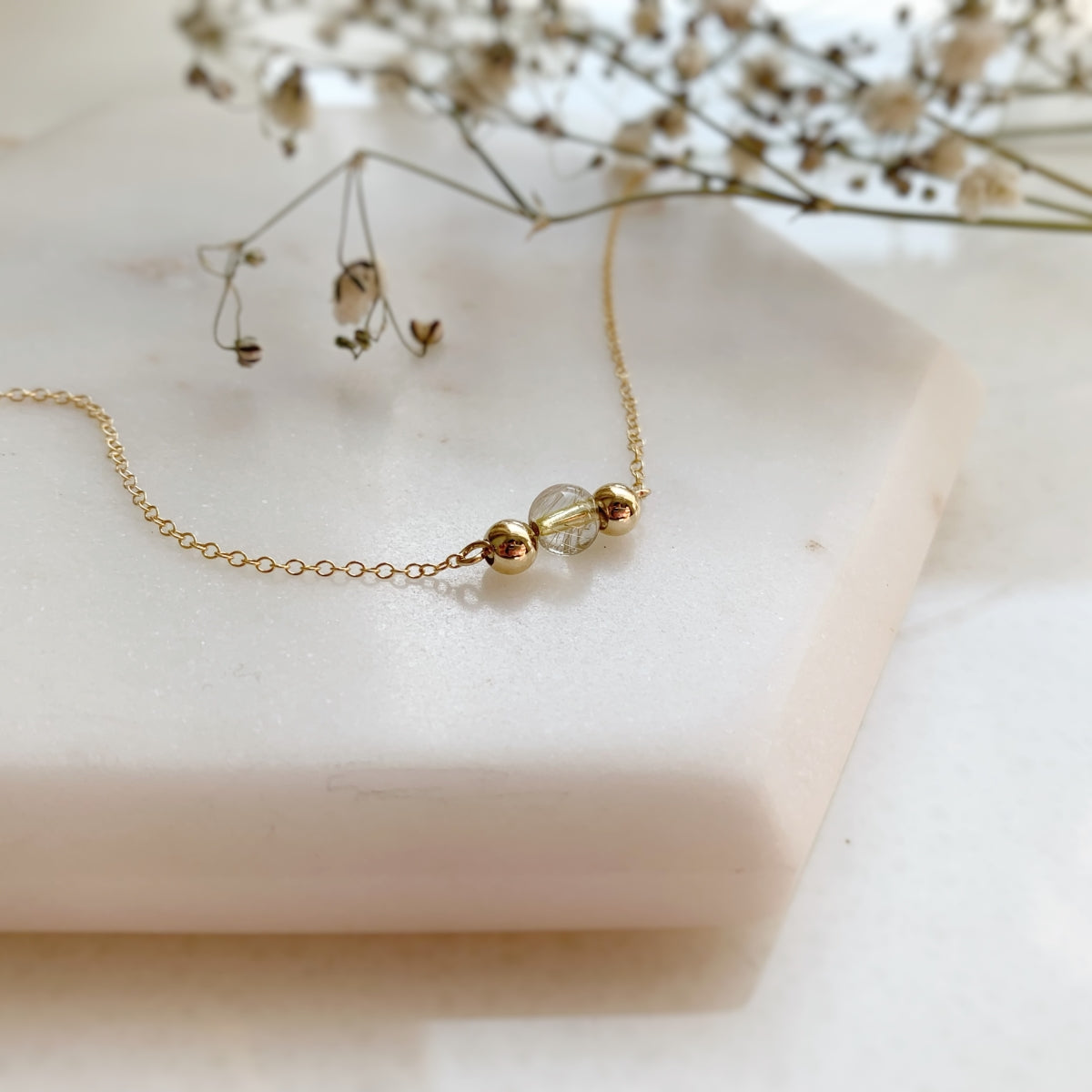 Three bead gold necklace with rutilated quartz centre bead