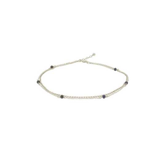 A layered silver anklet with natural sapphire gemstone beads