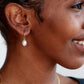 Model wearing baroque pearl small gold hoop earrings
