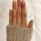 model wearing silver beaded stacking ring, twisted stacking ring, silver band and the square beaded stacking ring
